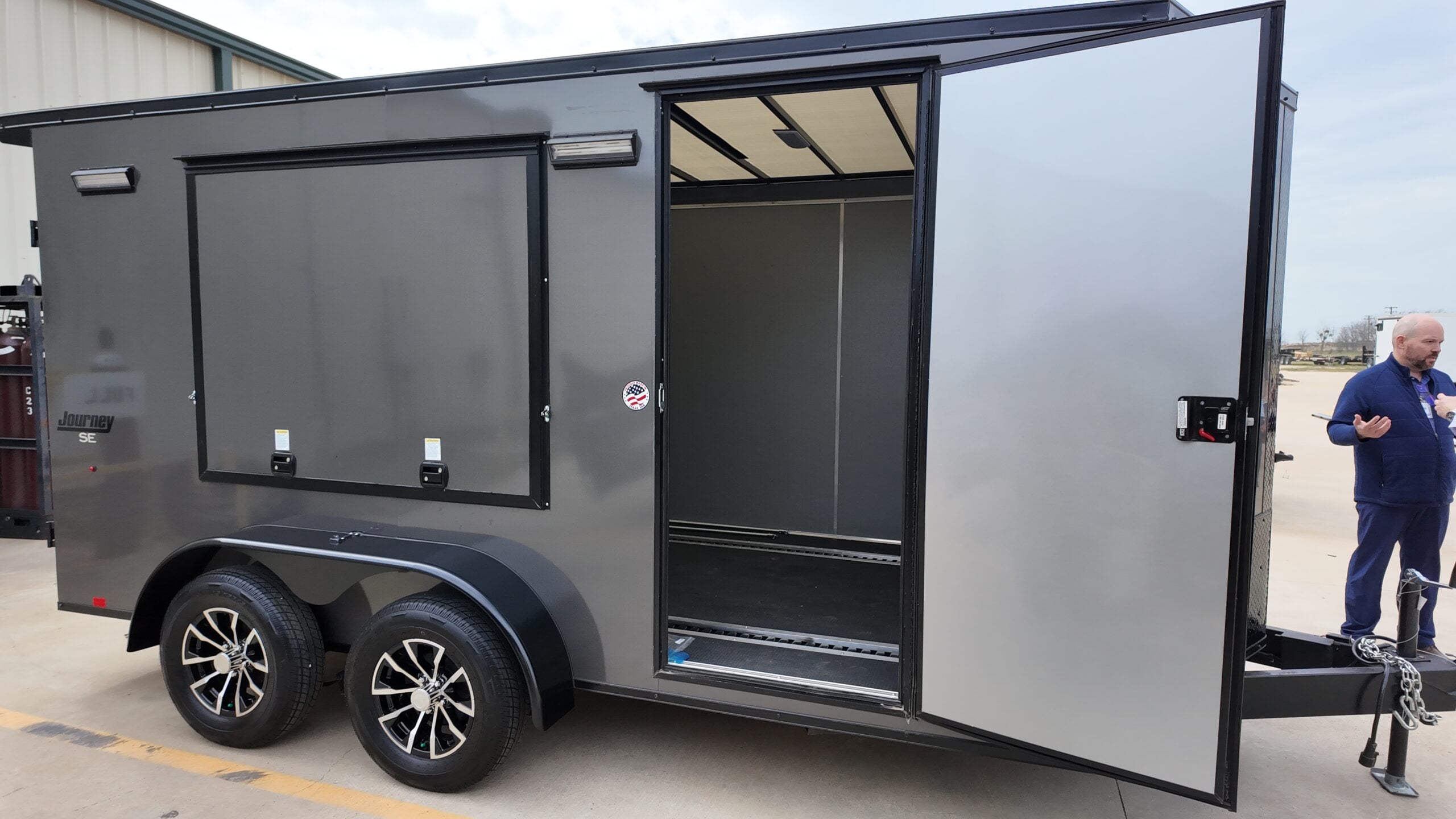 Cargo trailer with open door showing interior panels and components