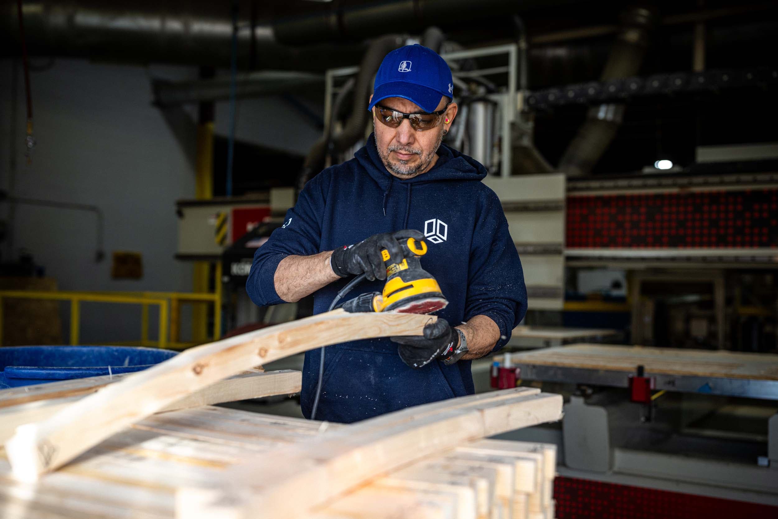 BRAWN craftsman sanding structural lumber on the production floor