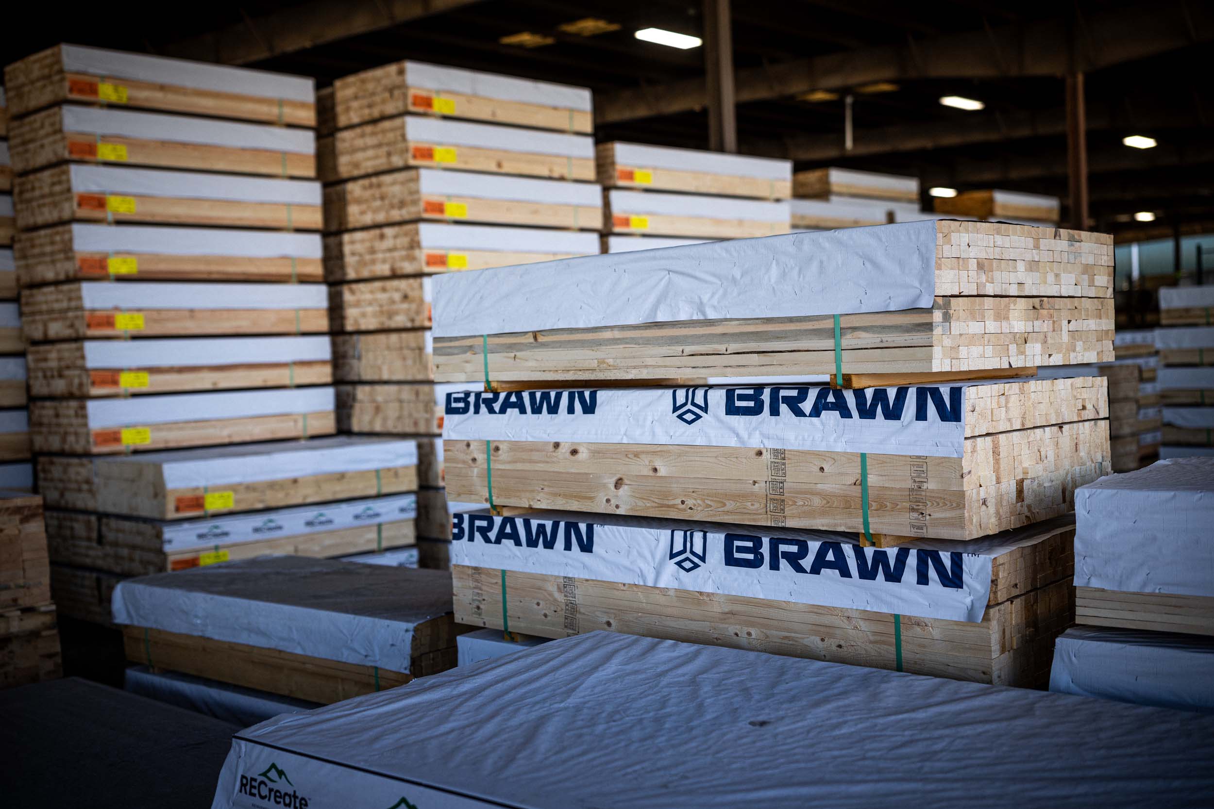BRAWN-branded structural lumber stacked in a warehouse